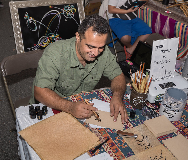 A calligraphy artist writing on fancy paper